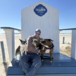 Man on giant chair with 2 dogs